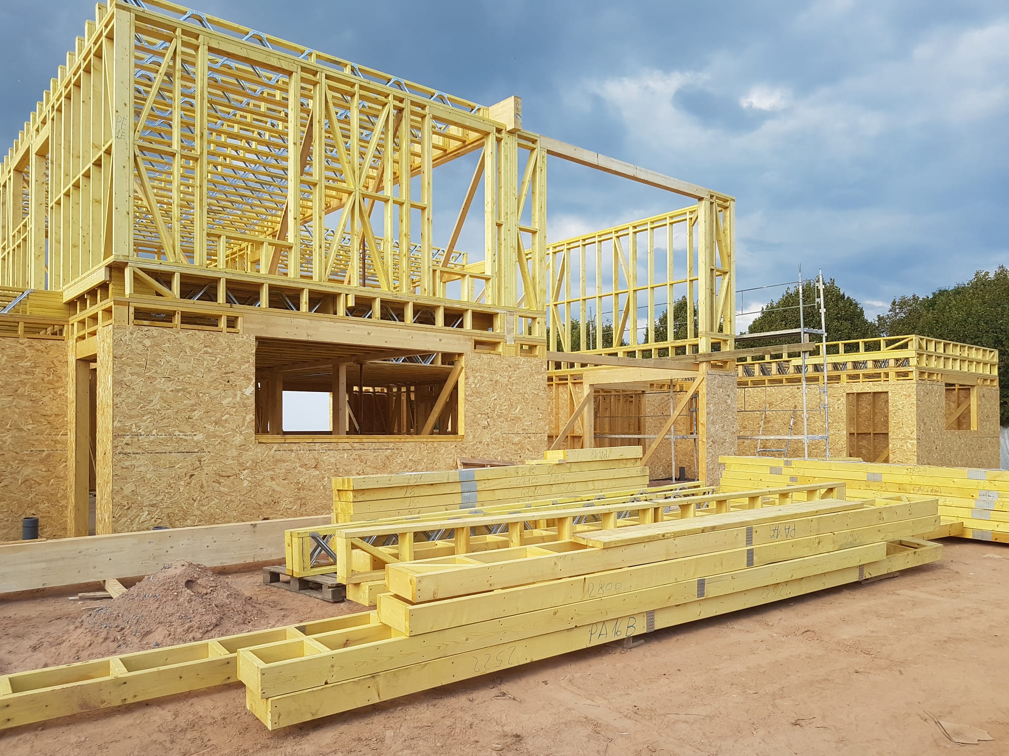 Factory floor: precision-cut timber frame elements awaiting delivery and site assembly